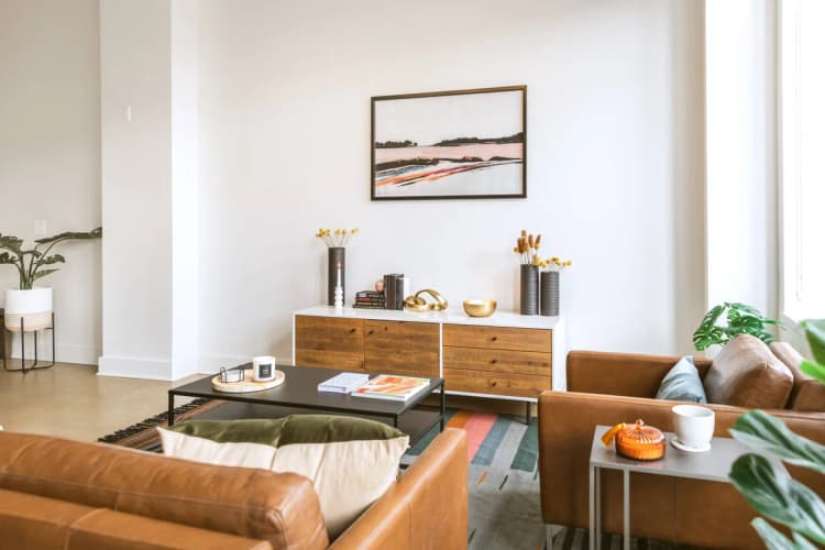 Detroit apartments for rent - image - a living room with white walls and brown leather furniture