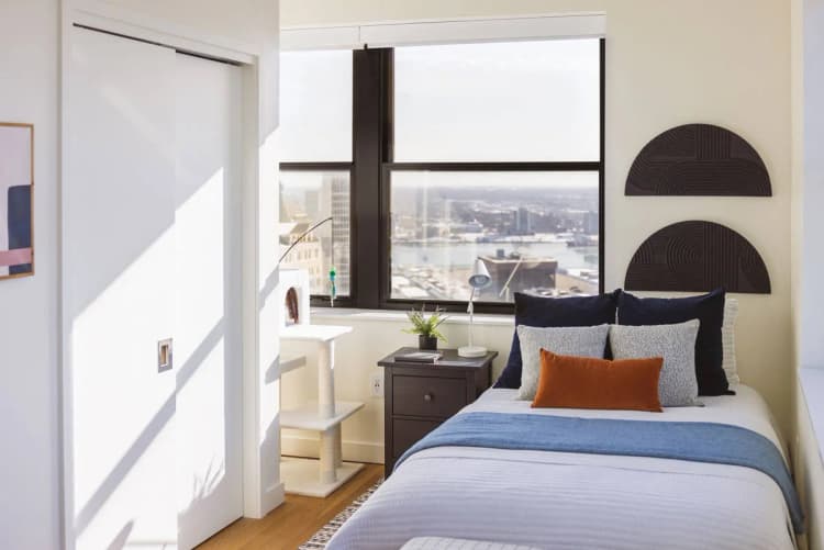 Detroit apartments for rent - image - Studio unit with a bed and a window with a city view