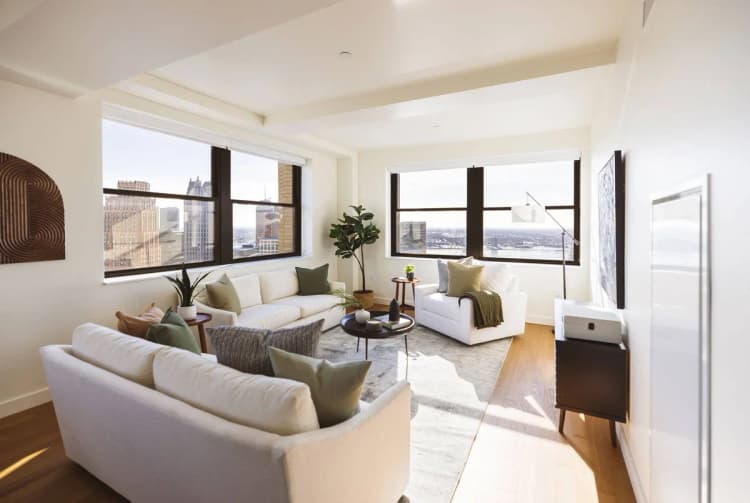 Detroit apartments for rent - image - One bedroom unit with a living room, couches and windows with a city view