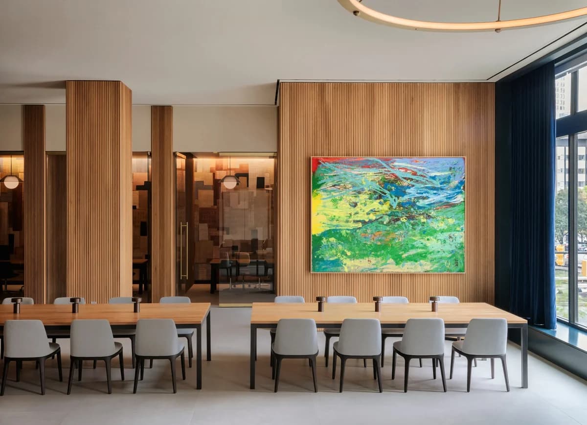 Detroit apartments for rent - image - a shared amenity conference room table and chairs and a painting on the wall