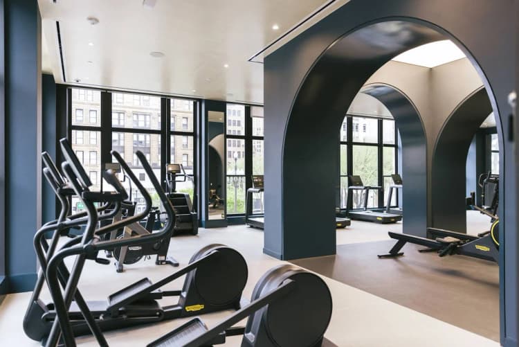 Detroit apartments for rent - image - a fitness center with cardio equipment and windows with view