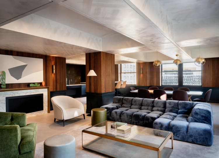 Detroit apartments for rent - image - a shared amenity living room with a blue couch and a coffee table