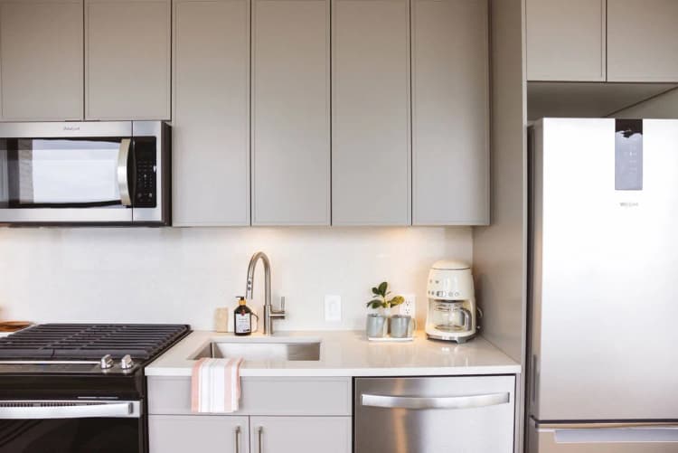 Detroit apartments for rent - image - Studio unit with a kitchen with stainless steel appliances and cabinets