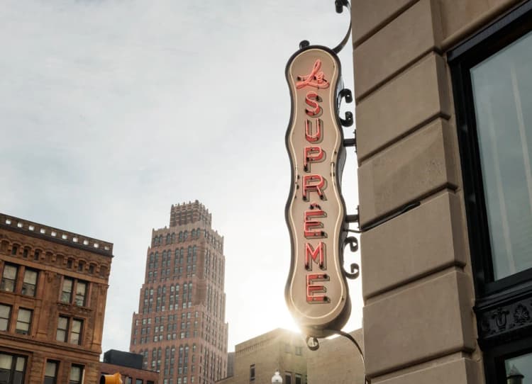 Detroit apartments for rent - image - a neon sign on the side of a building in the city