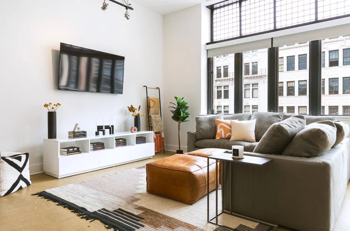 Detroit apartments for rent - image - a living room with a large window and a tv on the wall