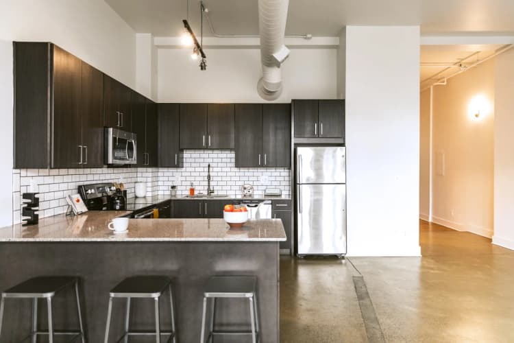 Detroit apartments for rent - image - a kitchen with black cabinets and stainless steel appliances