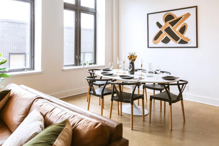 Detroit apartments for rent - image - a dining room with a table and chairs and a couch in a 555 waverly unit