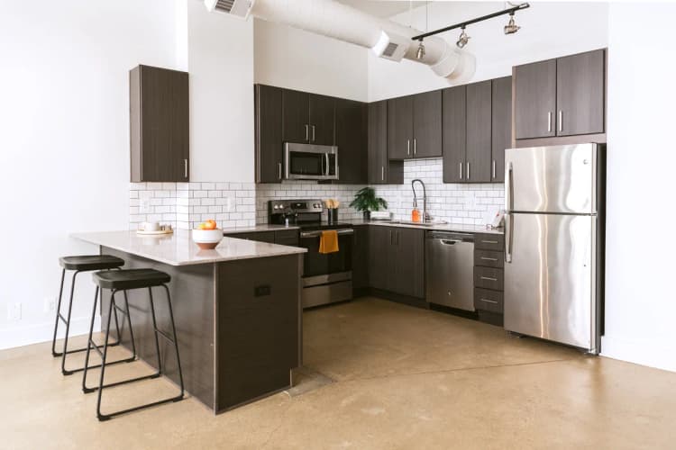 Detroit apartments for rent - image - a kitchen with a large island and stainless steel appliances