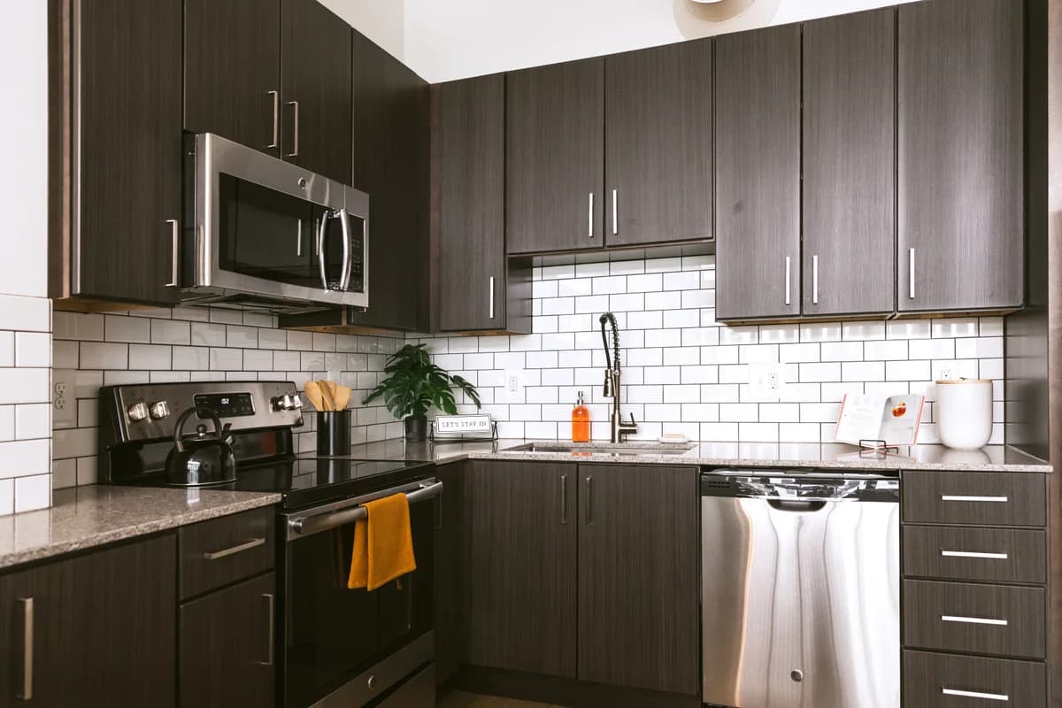 Detroit apartments for rent - image - a kitchen with dark cabinets and white tile